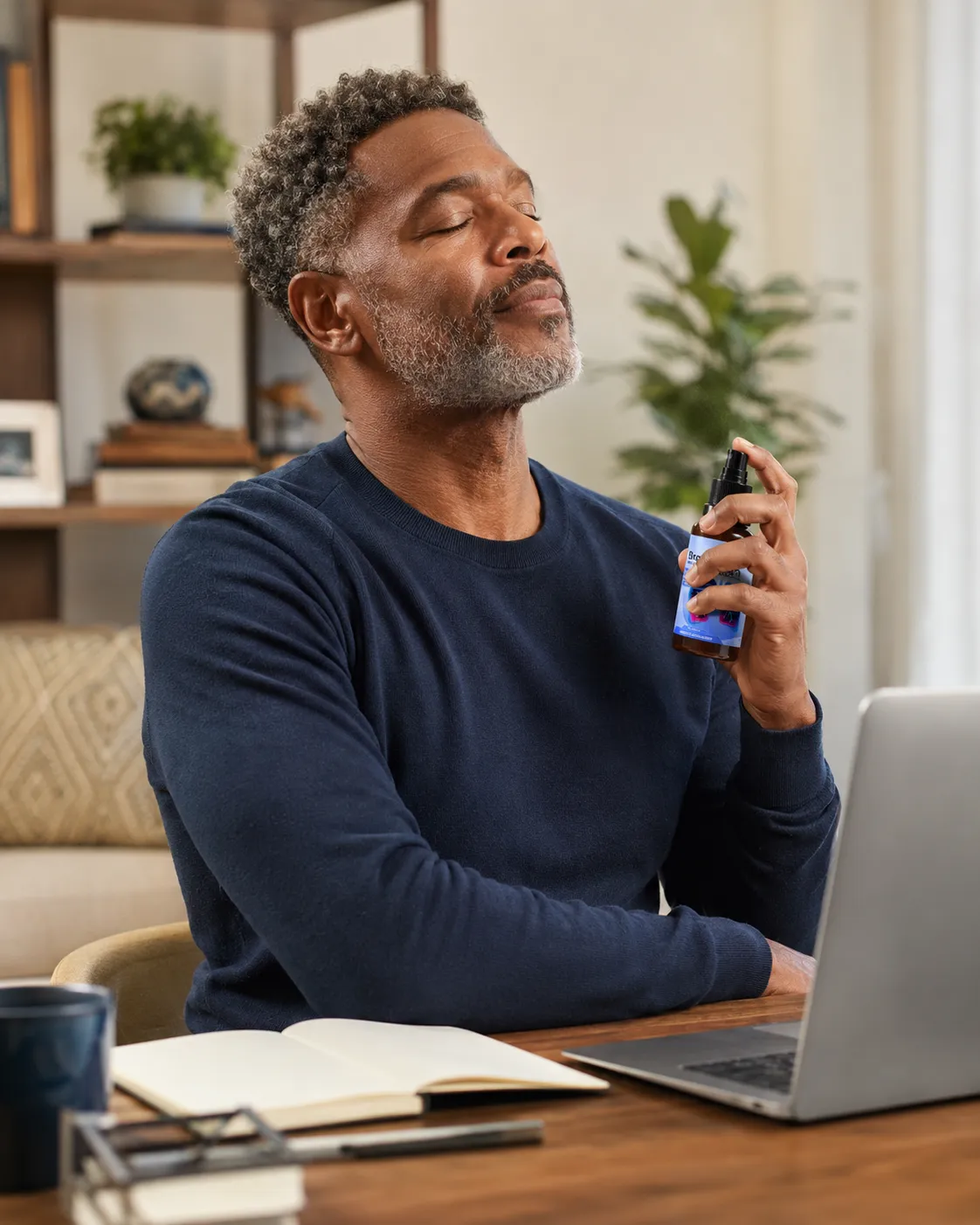Man using Breathizen oral spray during a work-from-home routine